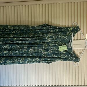 Dress: Green base with light floral patterns and a flowy, sleeveless design.